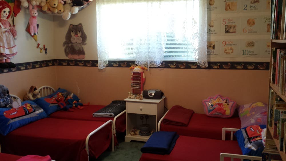 Room with multiple beds, a window, and shelves