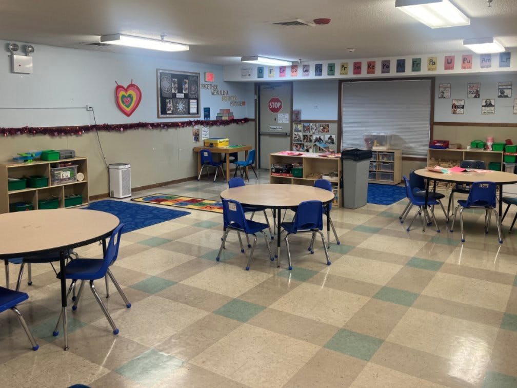 Empty classroom with tables and chairs