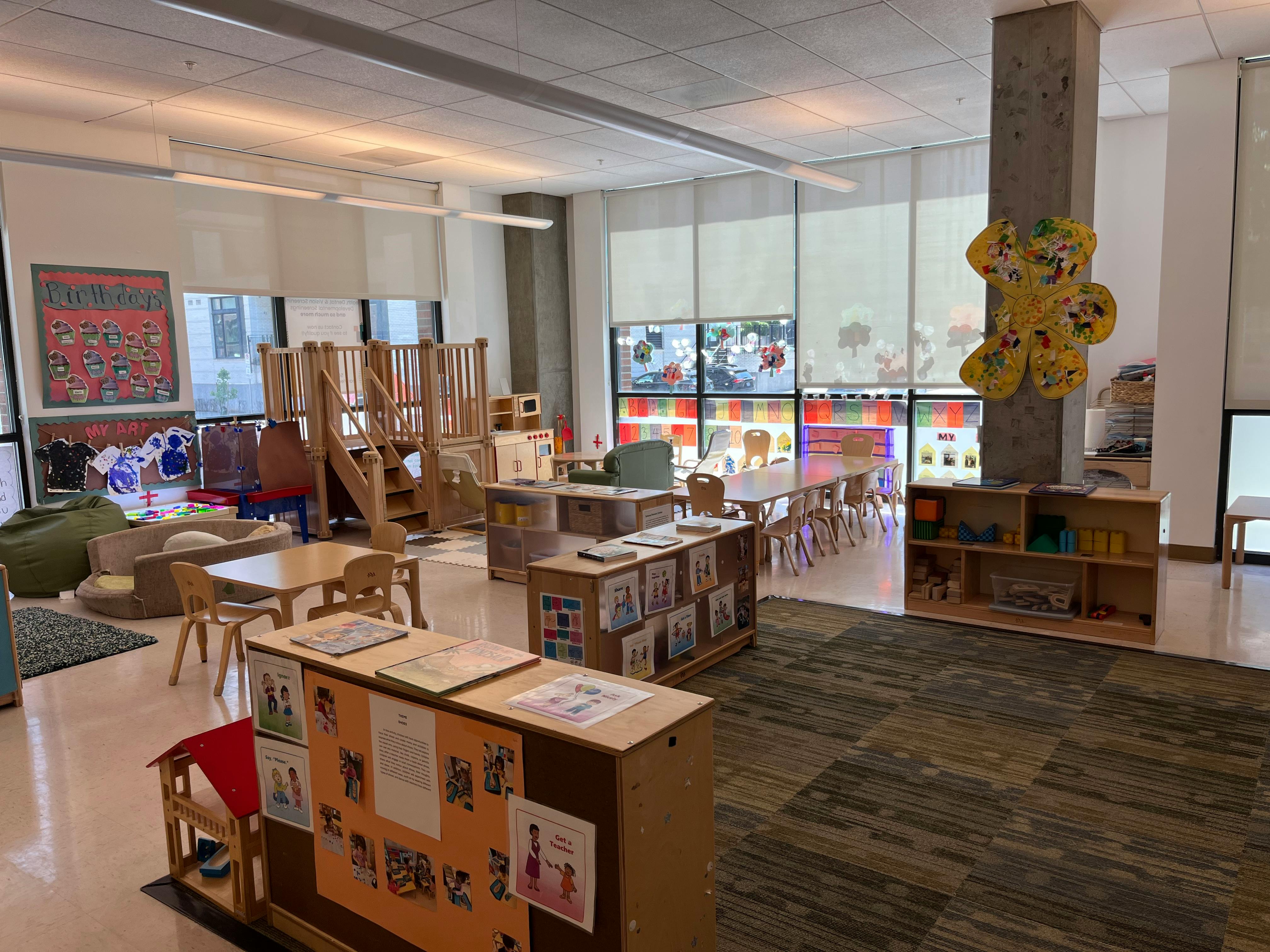 Classroom with play structures, tables, and shelves