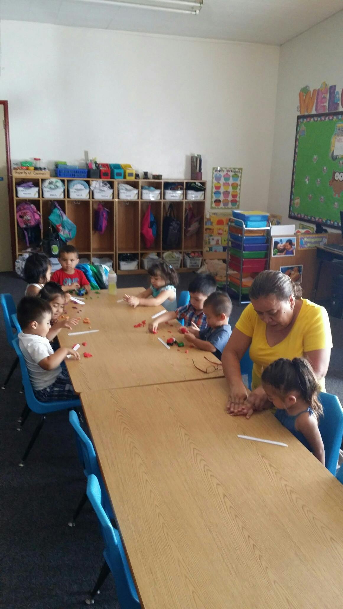 Adult and children at a table in a classroom