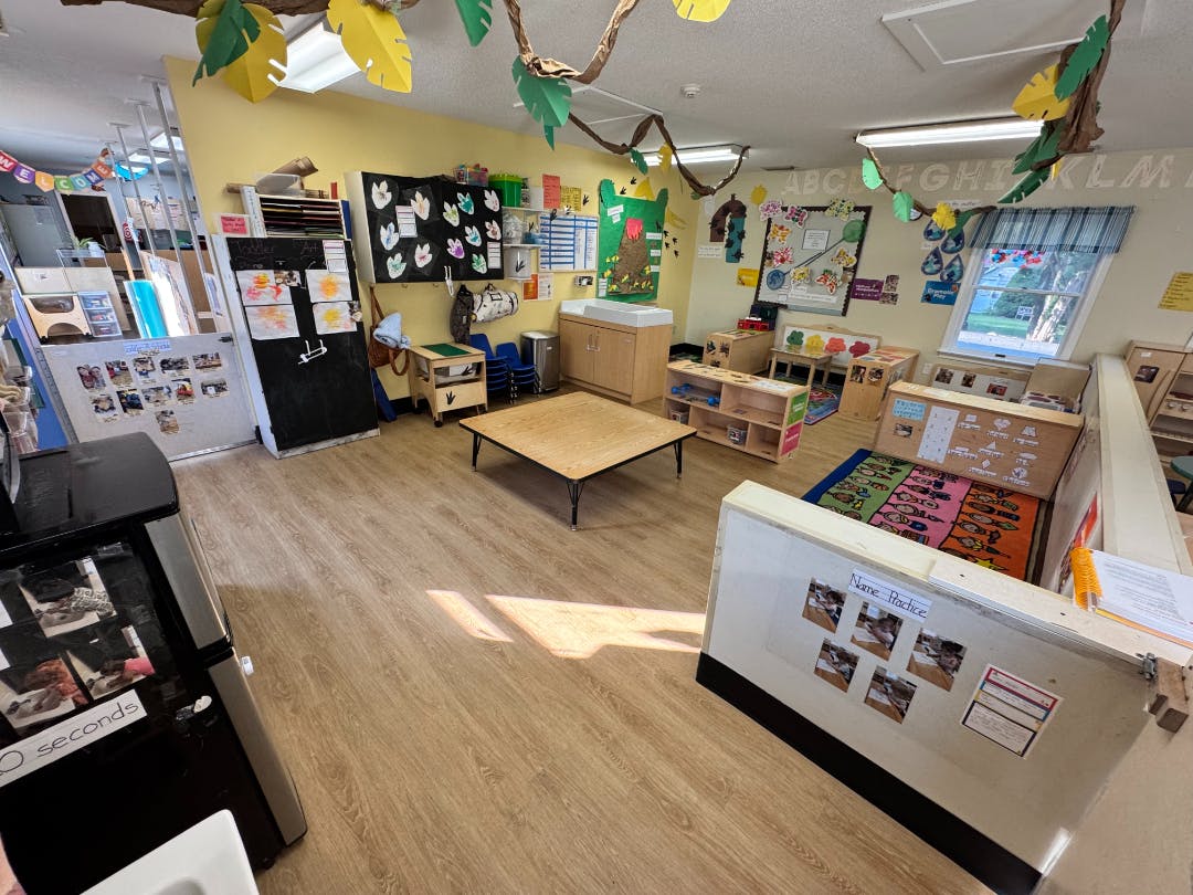 An empty early childhood classroom with toys and learning materials