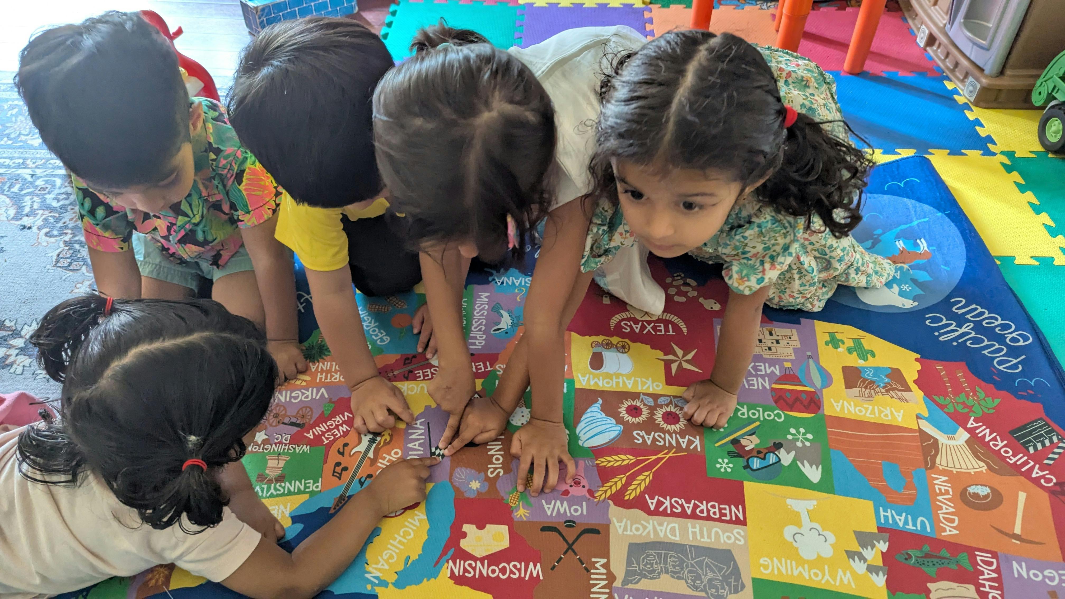 Children playing with a colorful floor puzzle