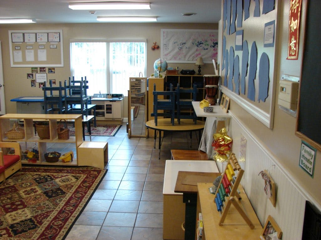 Classroom with small tables, chairs, and learning materials