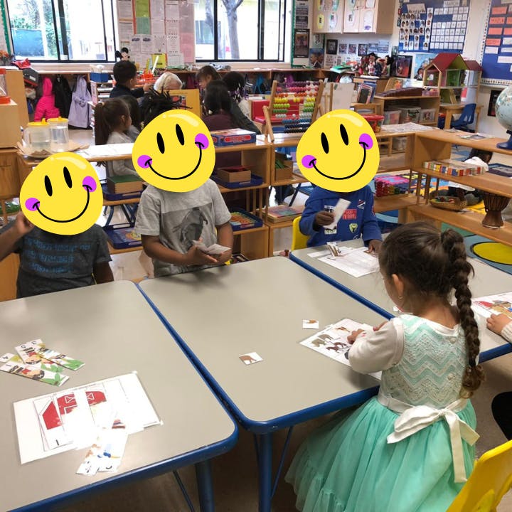 Children sitting at tables in a classroom