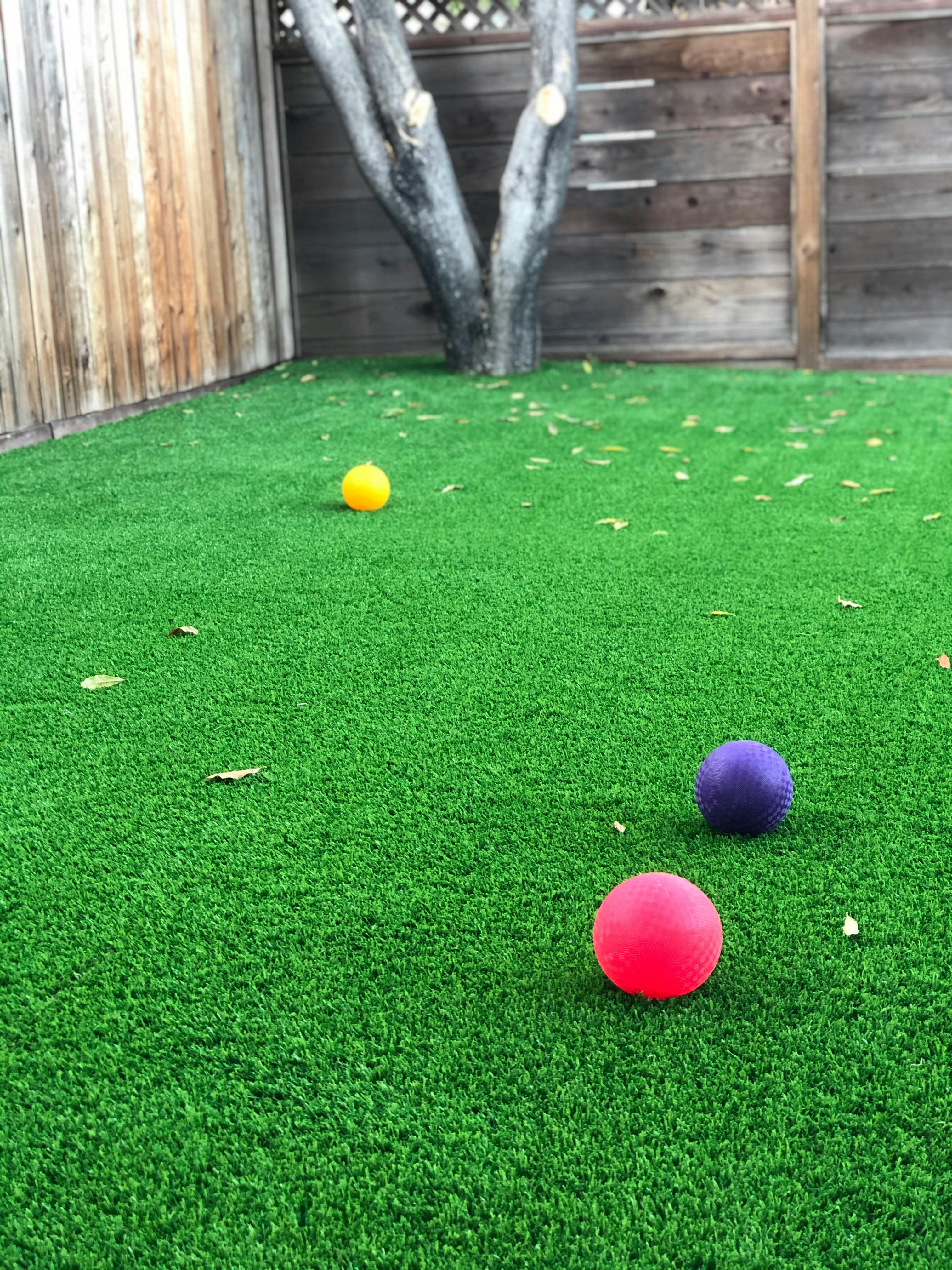Three balls on artificial grass