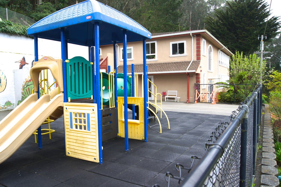 Playground with slides and climbing structures on a rubber surface
