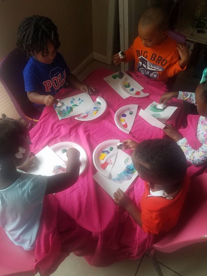 Children painting at a table