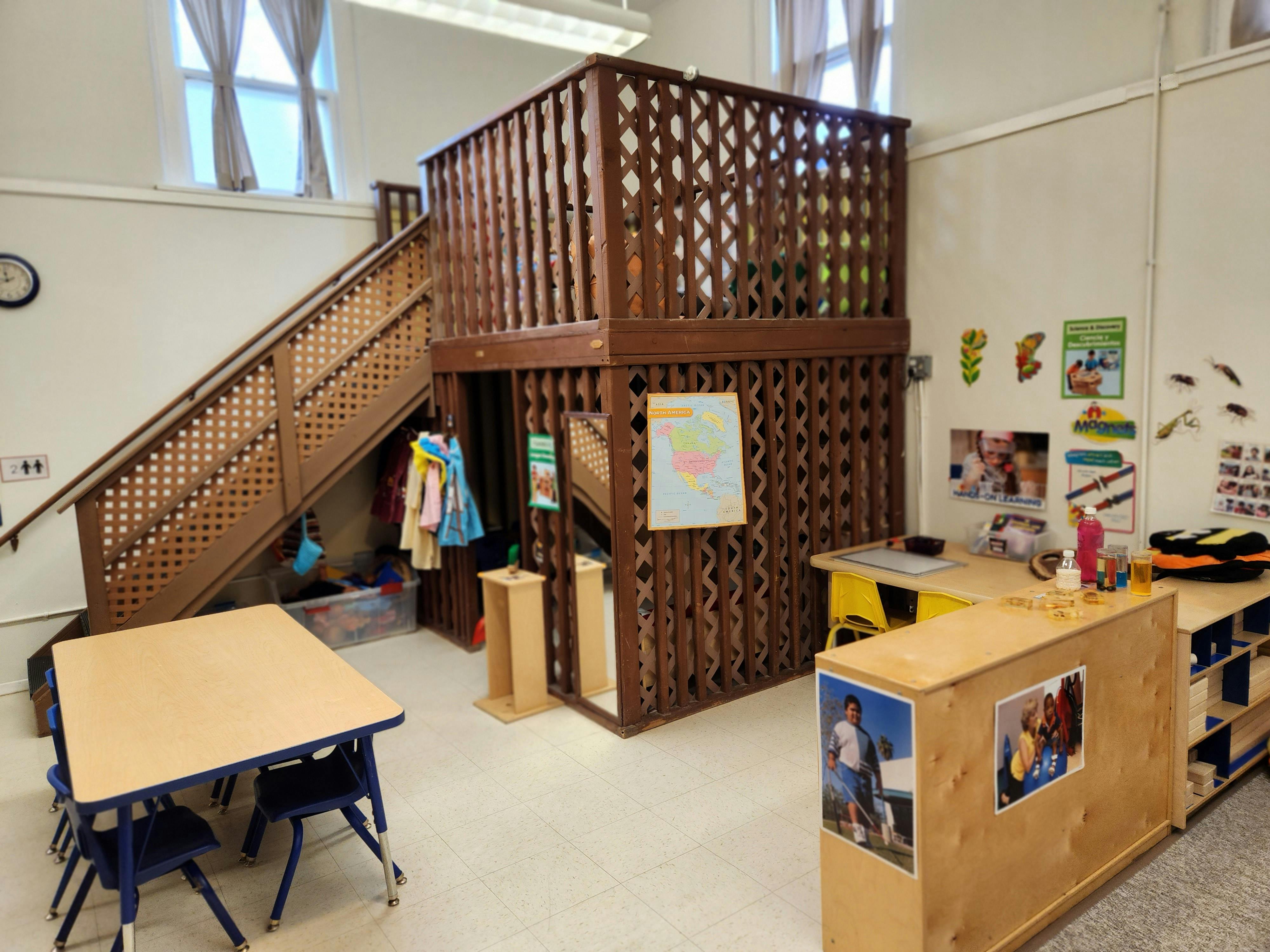 Indoor play structure with stairs and a small table with chairs