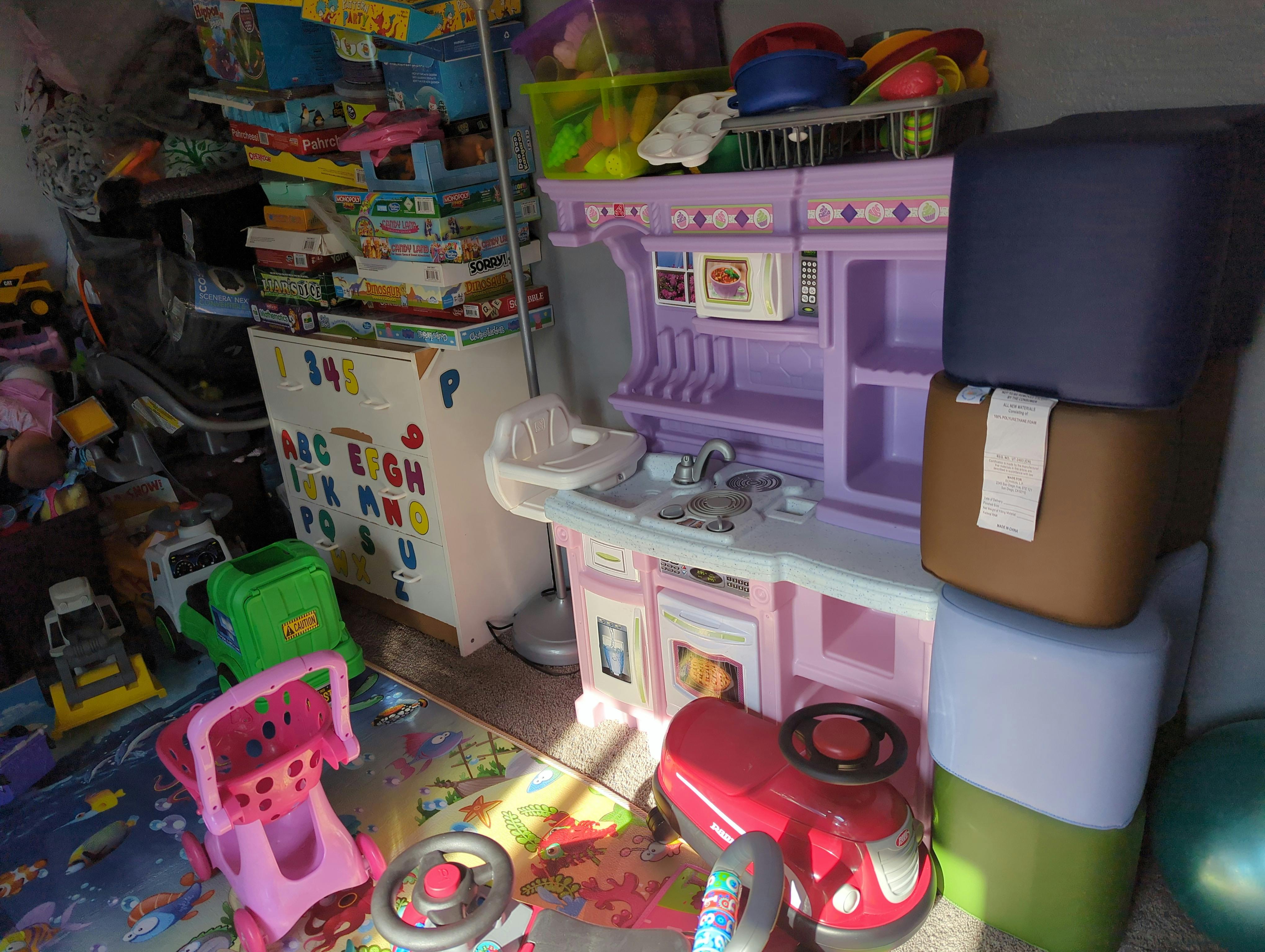 Children's play kitchen and toys in a room