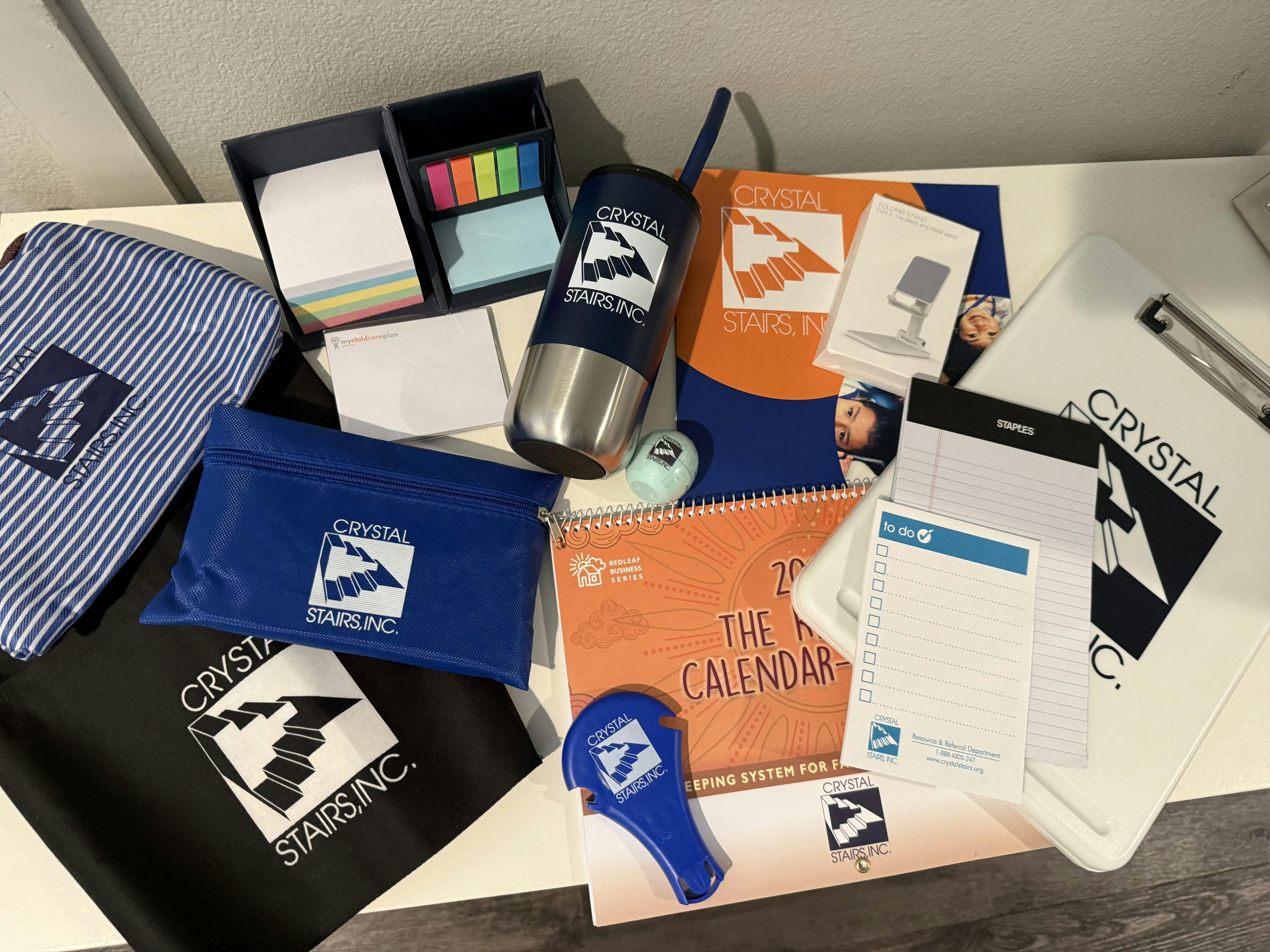 Collection of branded office supplies and promotional items for Crystal Stairs Inc