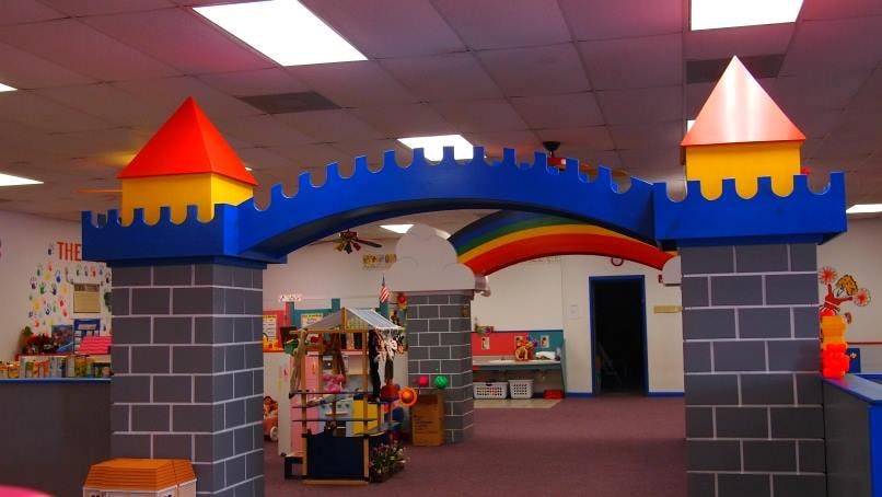 Play area with a blue castle archway and rainbow decoration