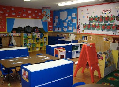 Classroom with tables, chairs, and colorful decorations on walls