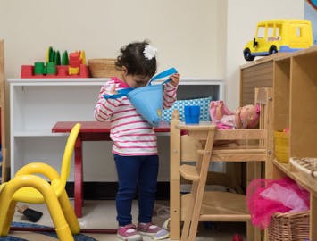 Child playing with a toy in a classroom