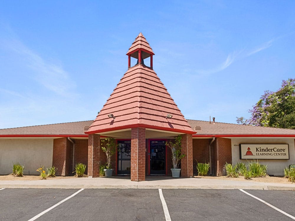 A KinderCare Learning Center building with a bell tower roof