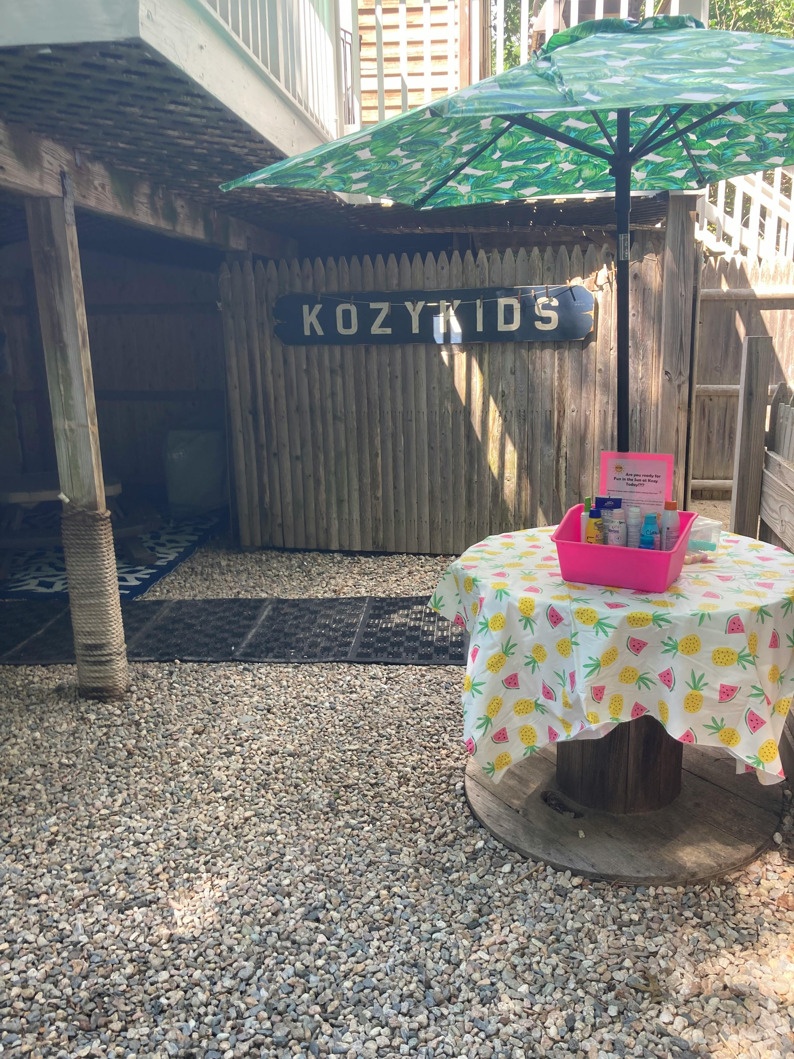 Outdoor area with a sign that reads "KOZYKIDS"