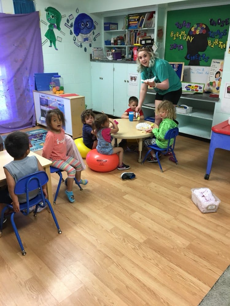 Adult and children in a classroom