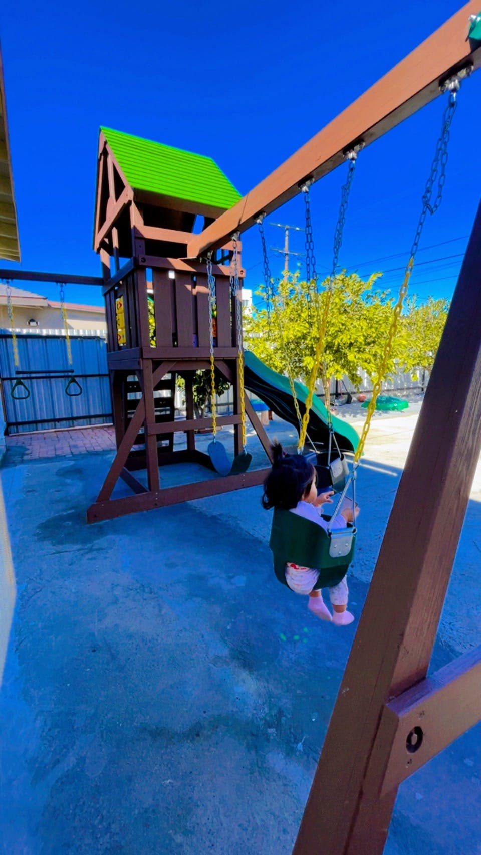 Child on a swing set in a playground