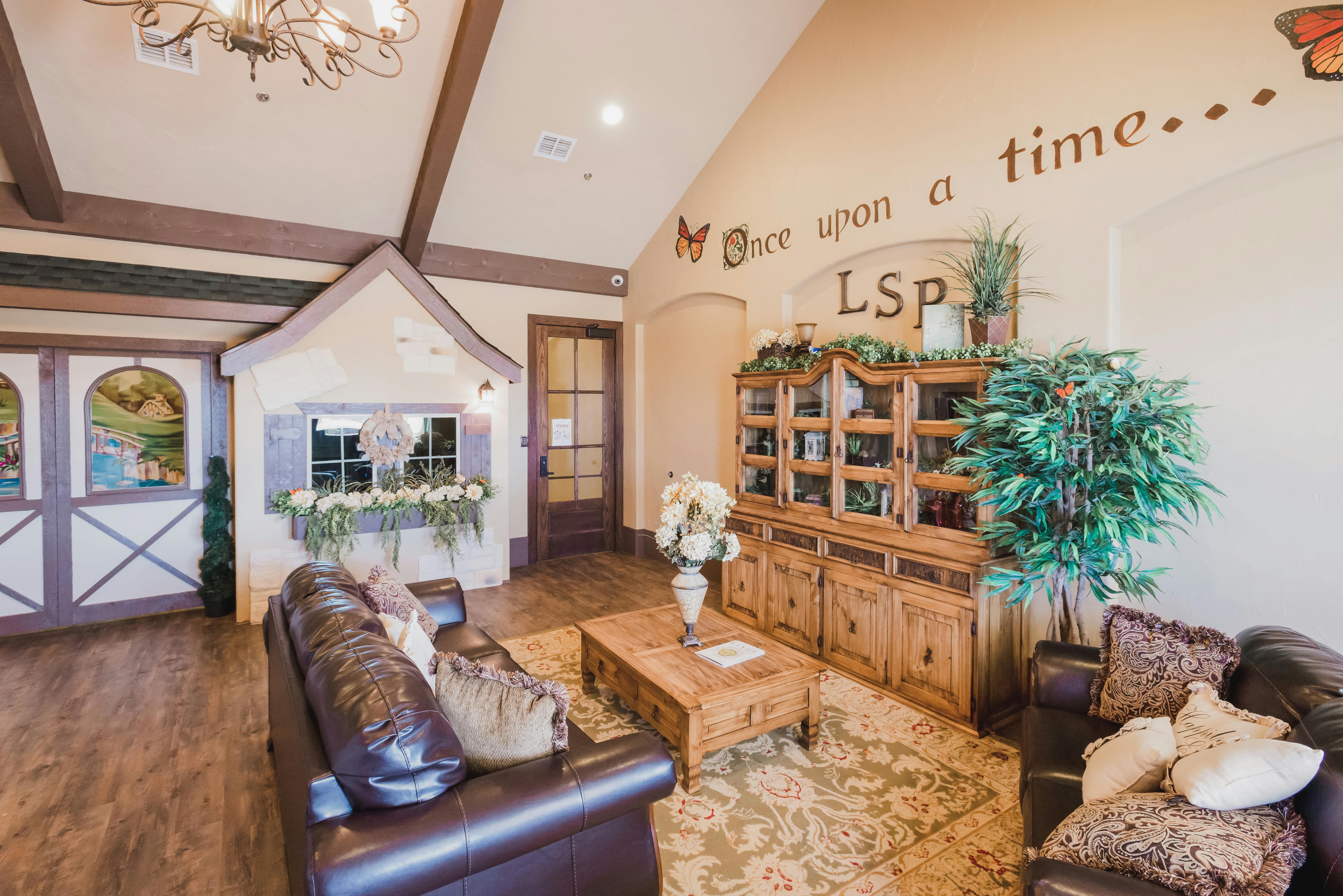 Living room with couches, coffee table, and a playhouse structure