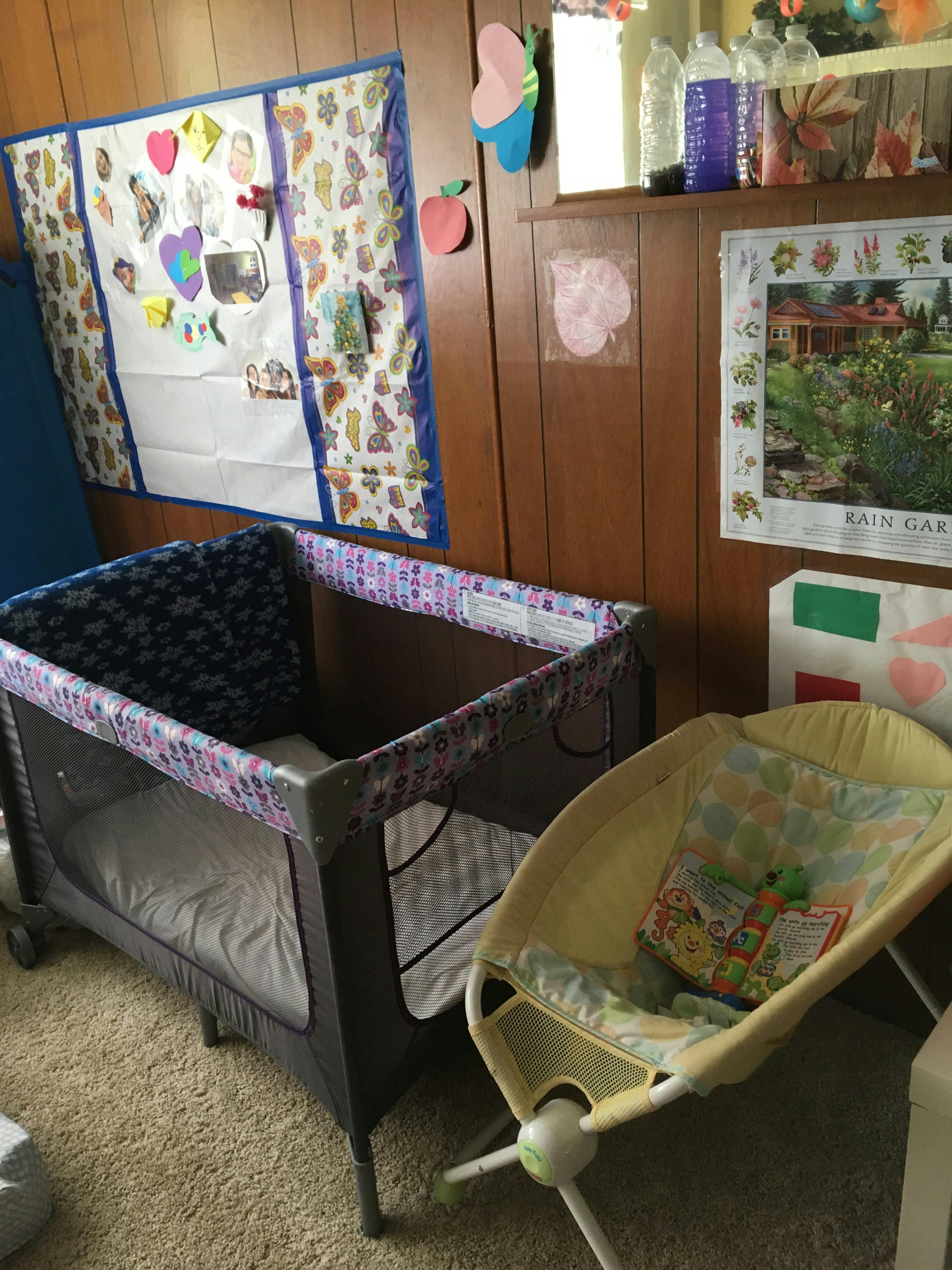 Playpen and baby bouncer in a room