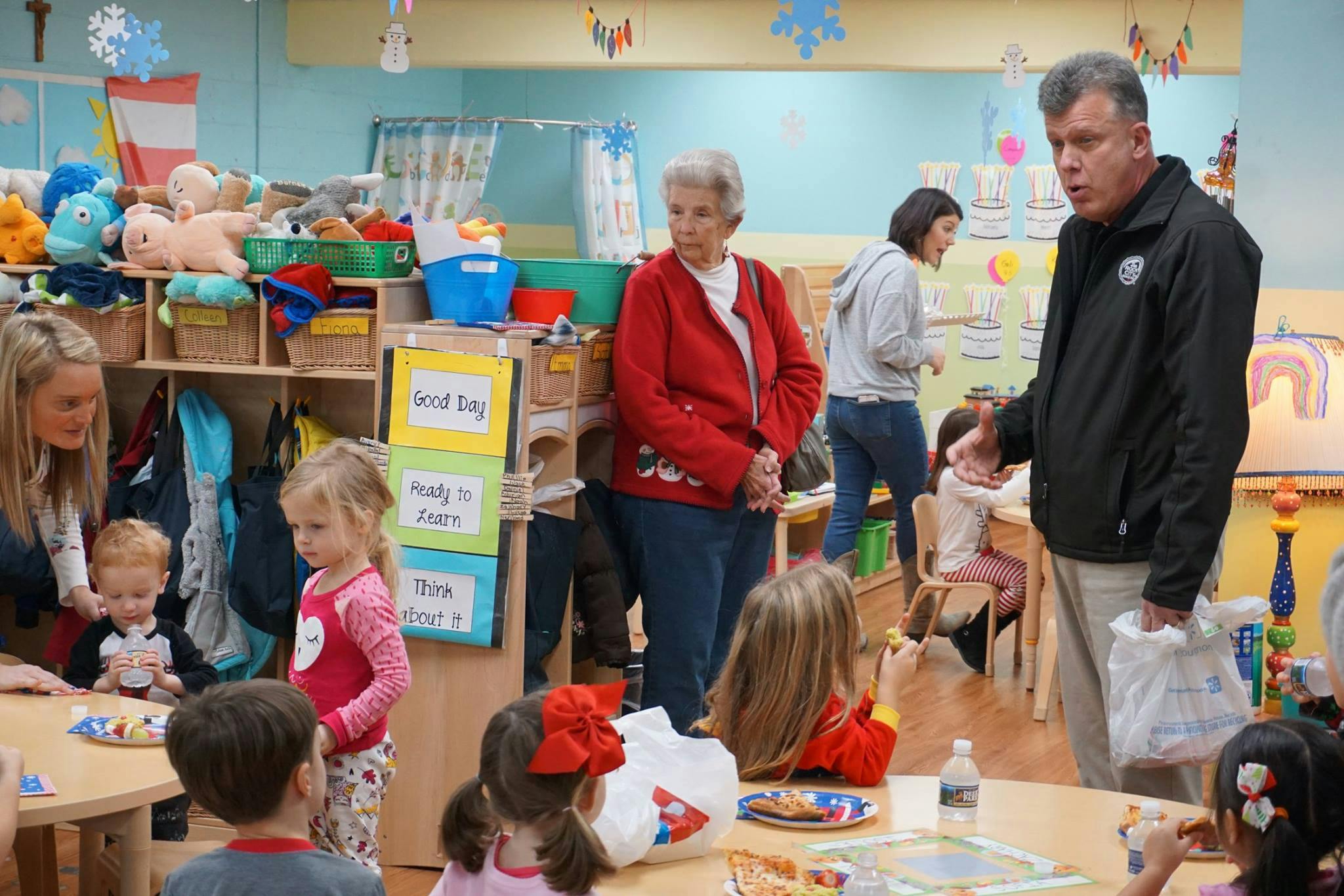 Adults and children in a classroom setting