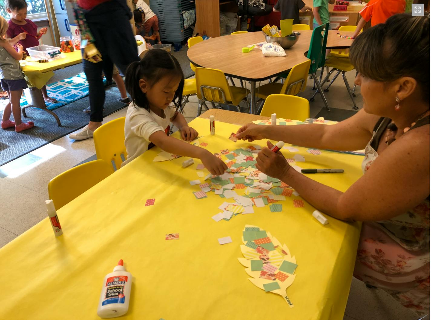 Adult and child doing crafts at a table