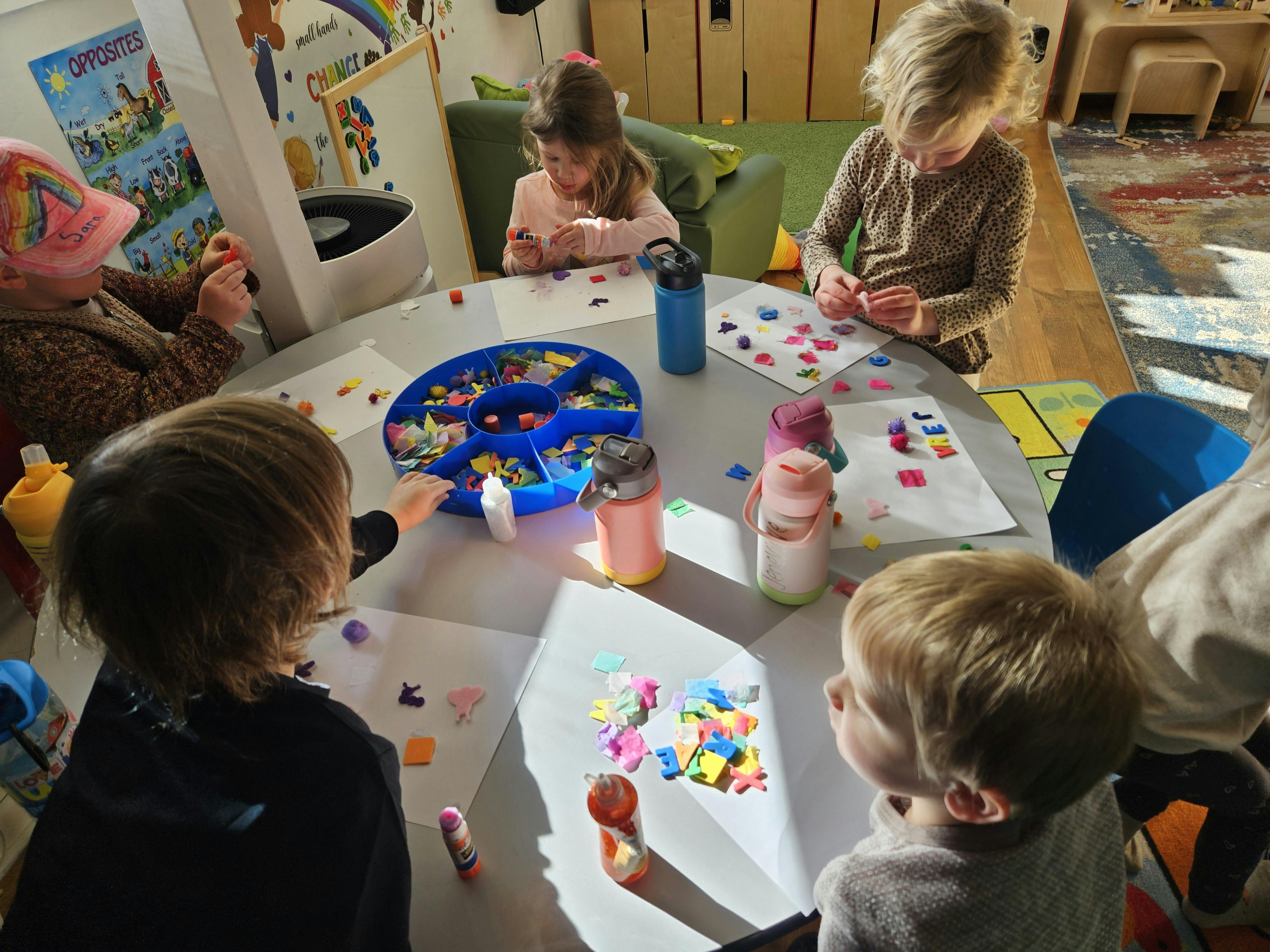 Children sitting around a table doing crafts