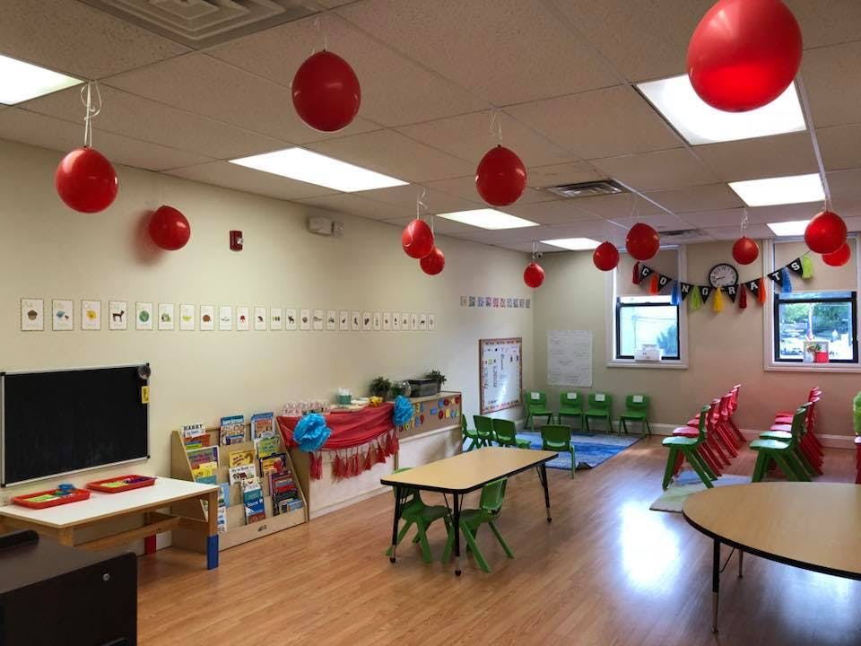 Classroom with red decorations, small tables, and chairs