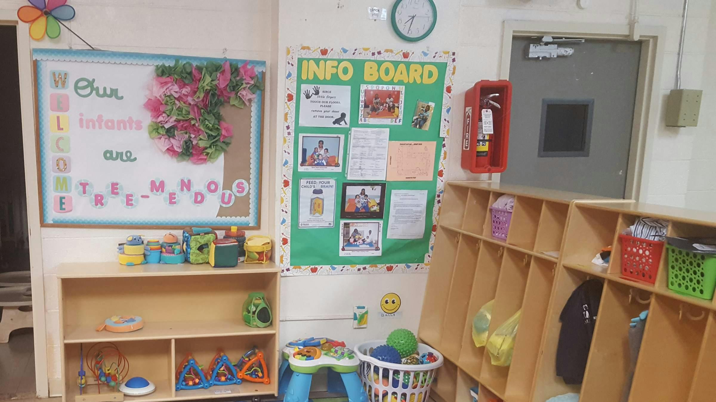 Classroom with bulletin boards, cubbies, and shelves with toys