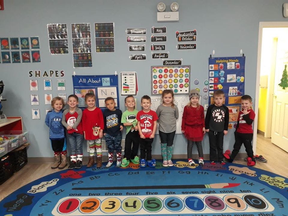 Group of children standing in a classroom