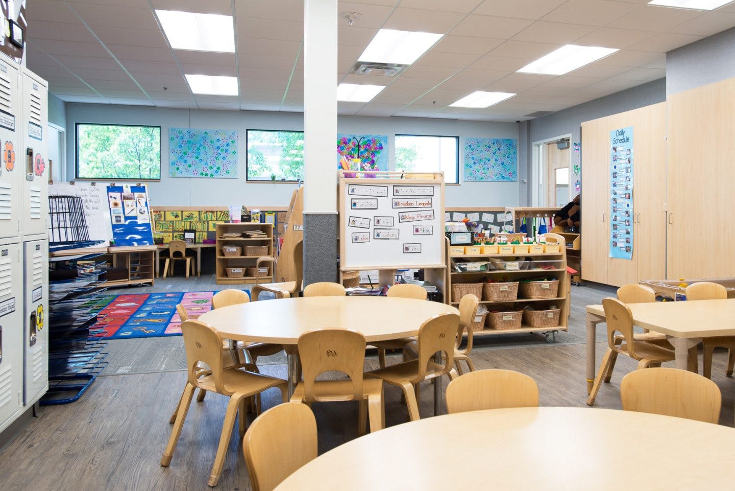 Empty classroom with small tables and chairs