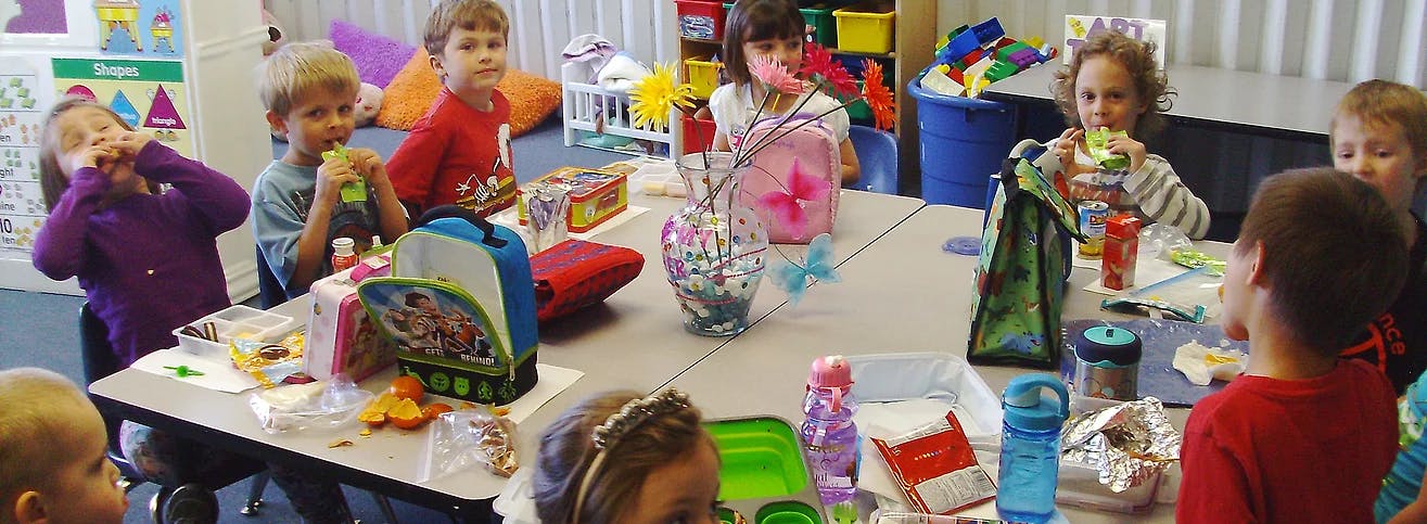 Children sitting around a table in a classroom