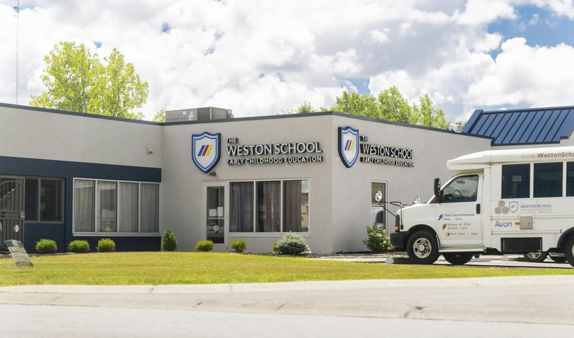 The Weston School Early Childhood Education building with a white bus