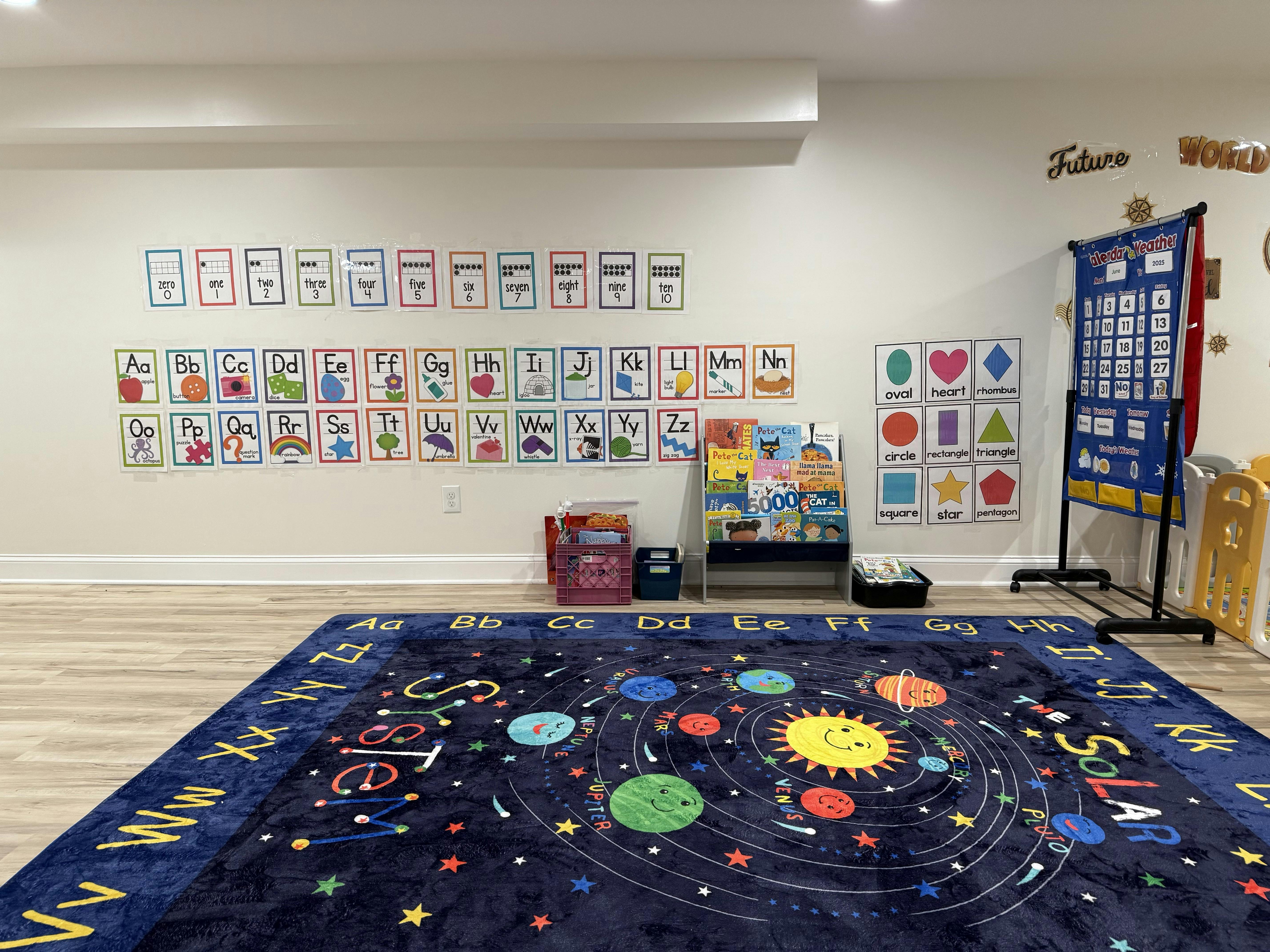 Classroom with alphabet cards on wall and solar system rug
