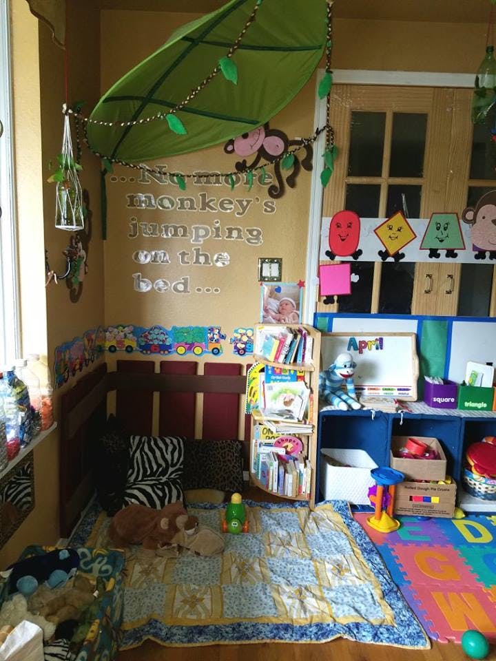 Child's play area with toys, books, and wall decorations