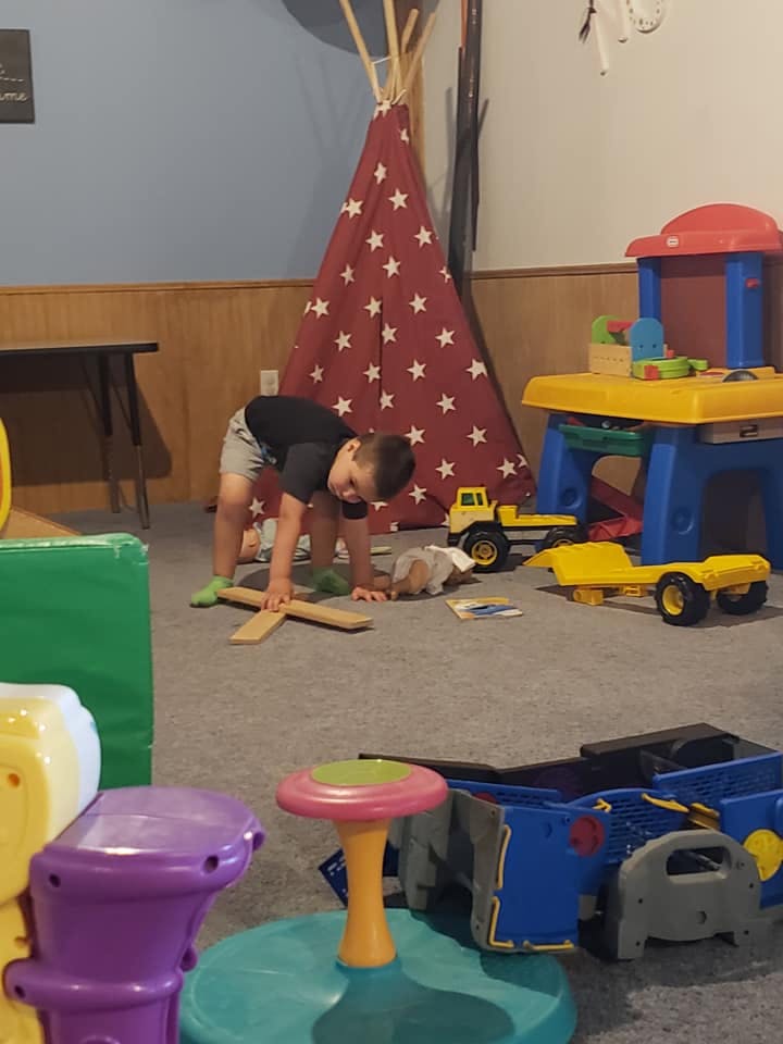 Child playing on the floor with toys