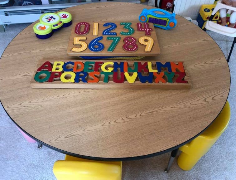 Alphabet and number puzzles on a round wooden table