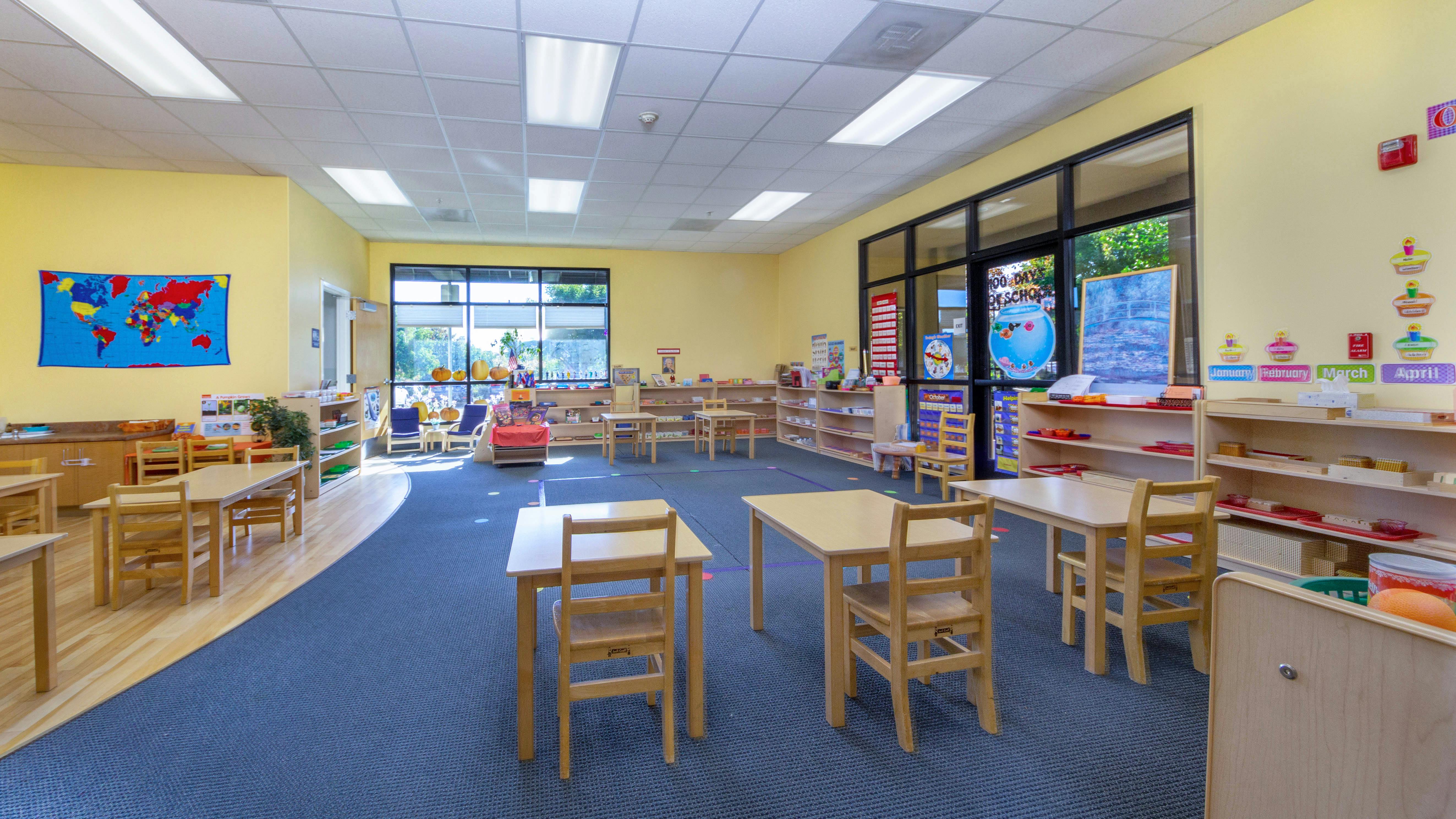 Empty classroom with small tables and chairs