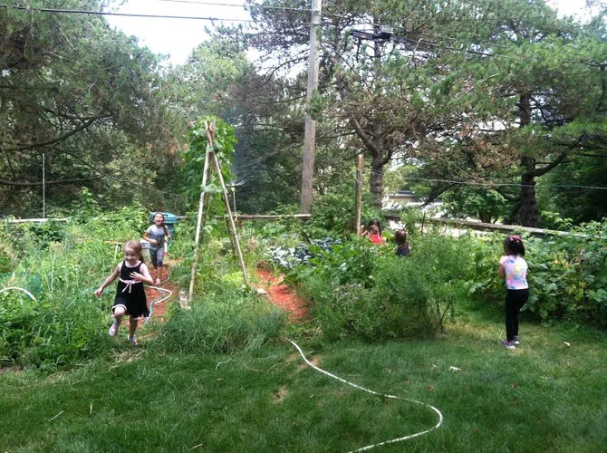 Children running through a garden