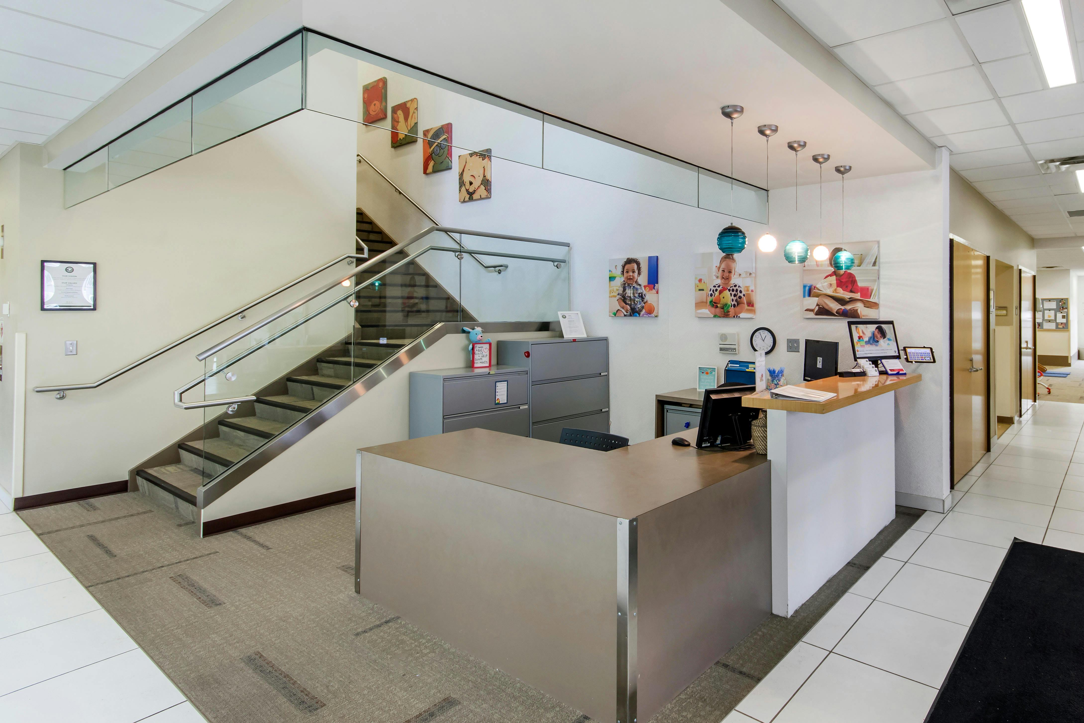 Reception desk and staircase in an office lobby
