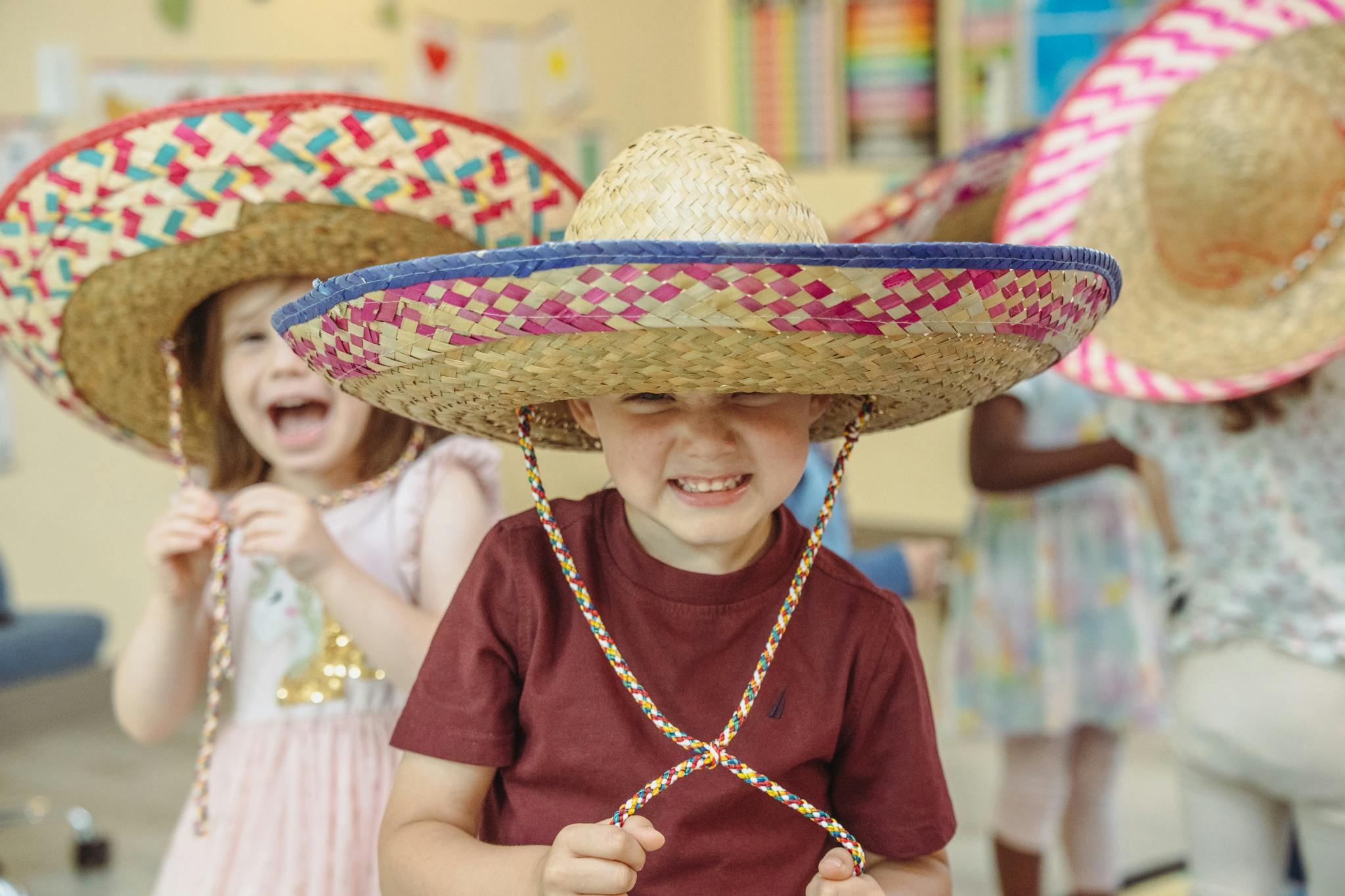 Two children wearing sombreros