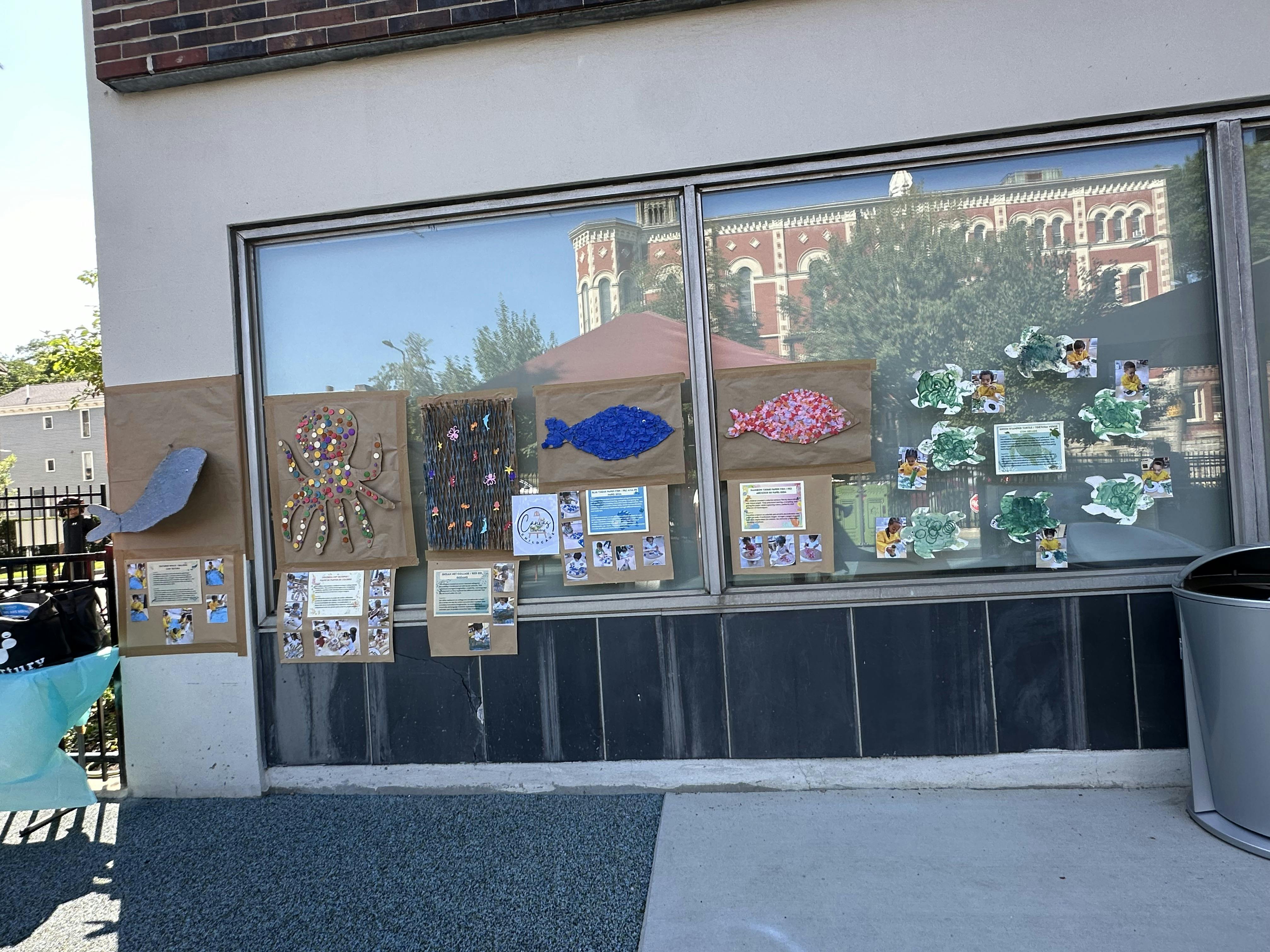 Children art projects featuring sea creatures displayed on a window