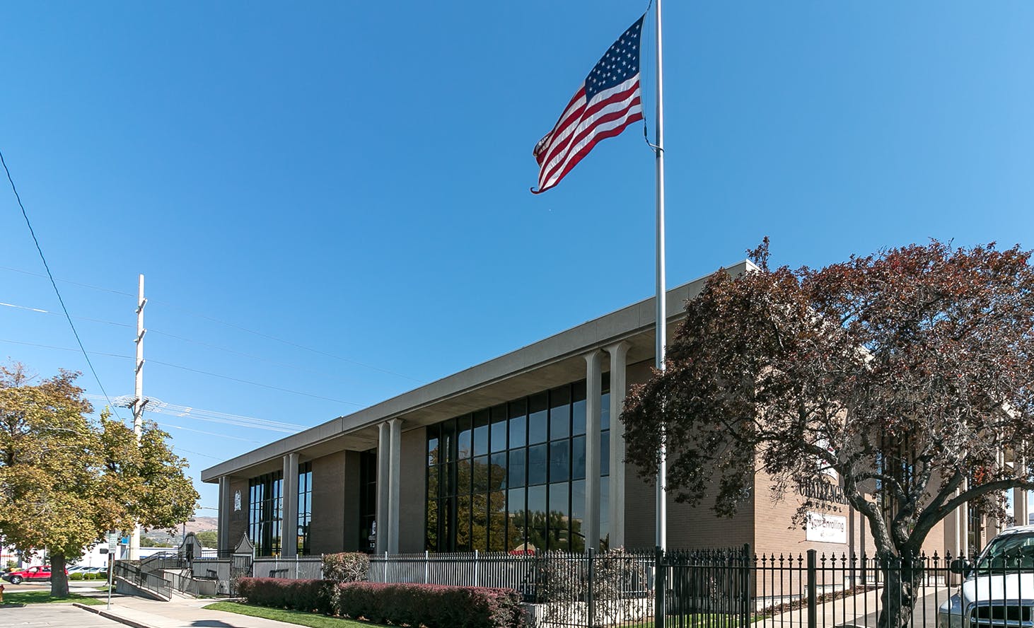 American flag flying at half-mast in front of a building
