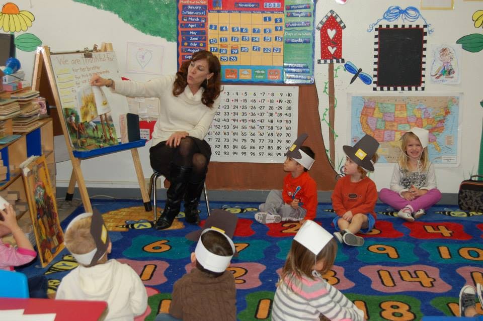 Person reading to children in a classroom
