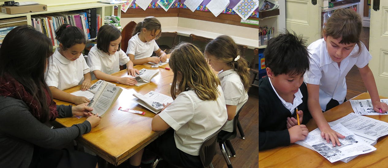 Teacher and five children reading and writing in a classroom