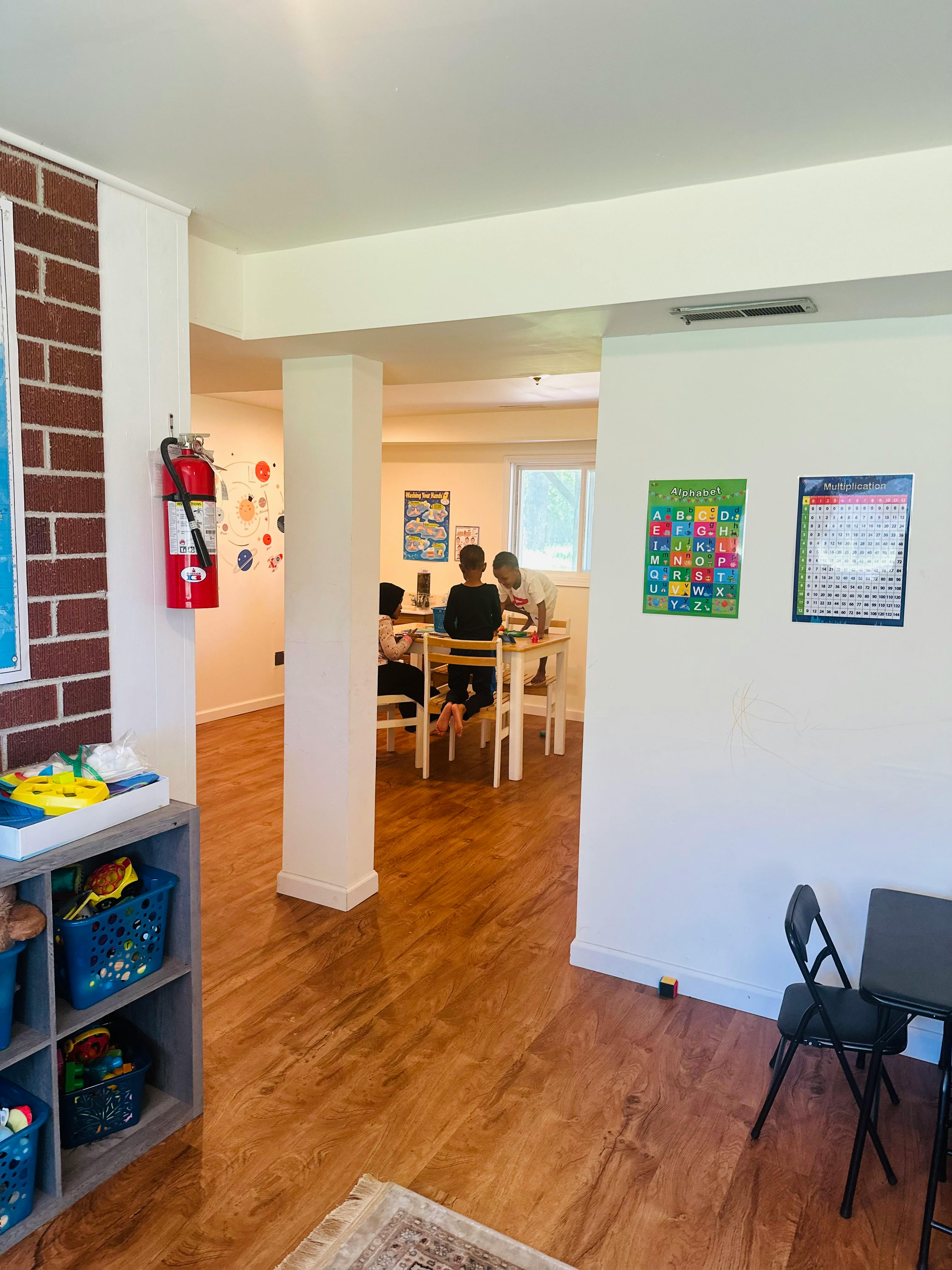 People sitting at a table in a room with posters on the wall