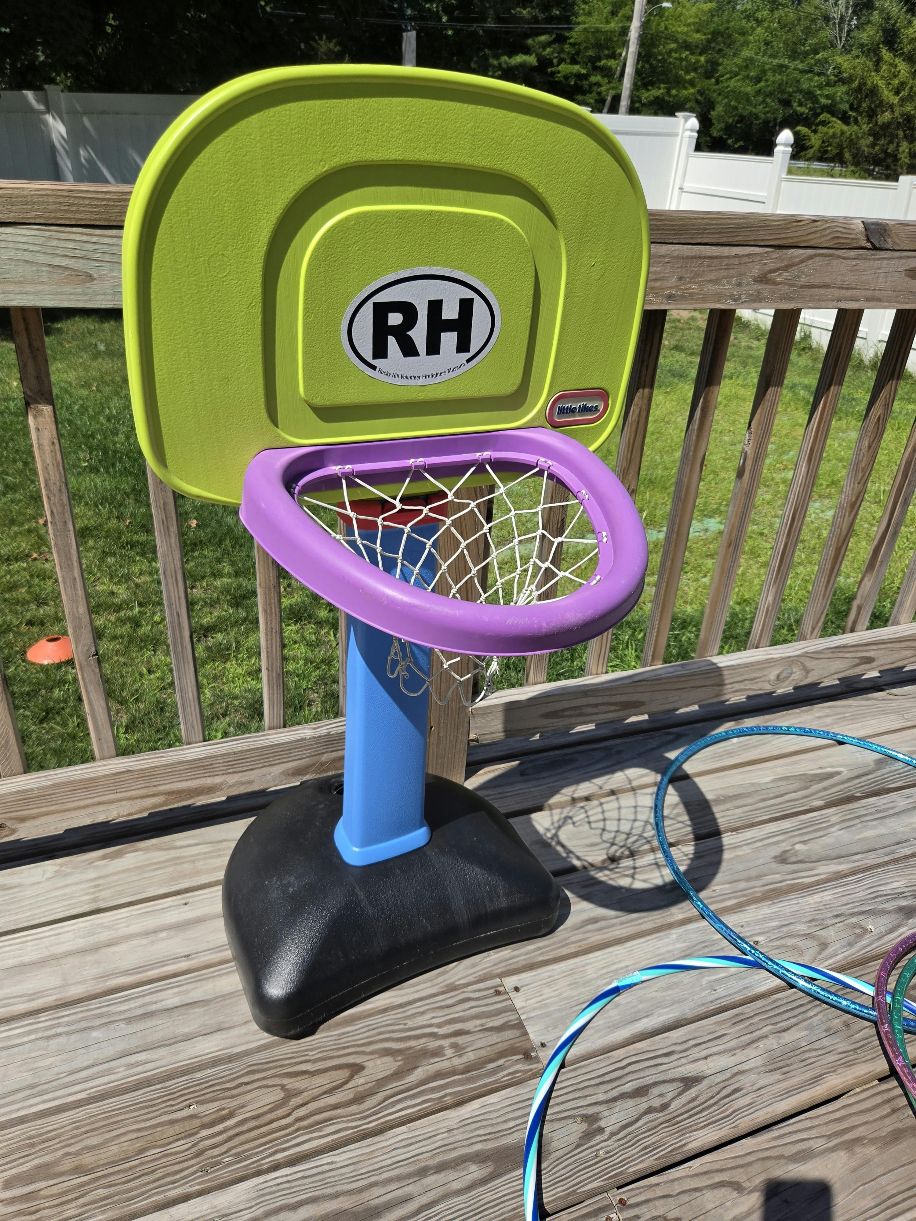 Plastic toy basketball hoop on a deck