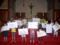 Children holding up drawings