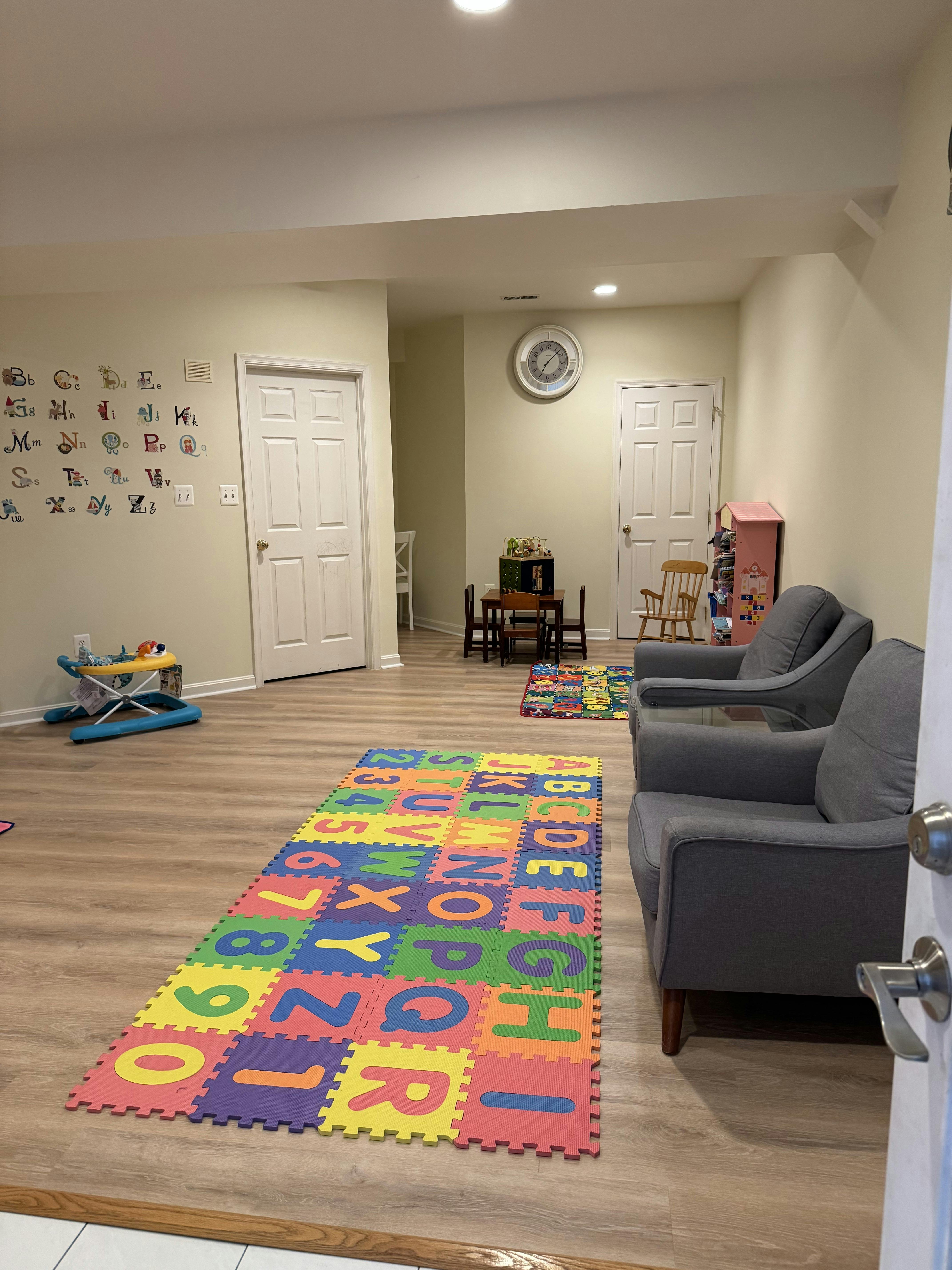 Playroom with alphabet floor mats and small table and chairs