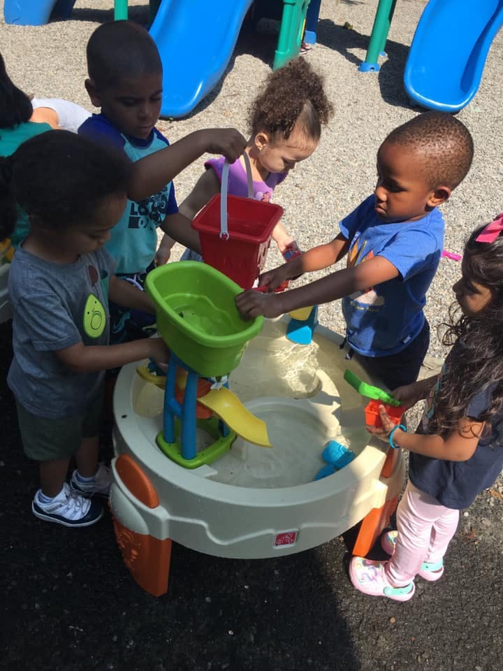 Children playing with a water table