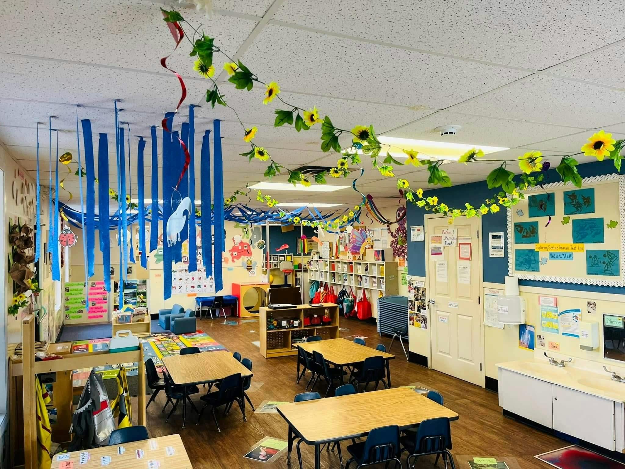 Classroom decorated with blue streamers and yellow flower garlands